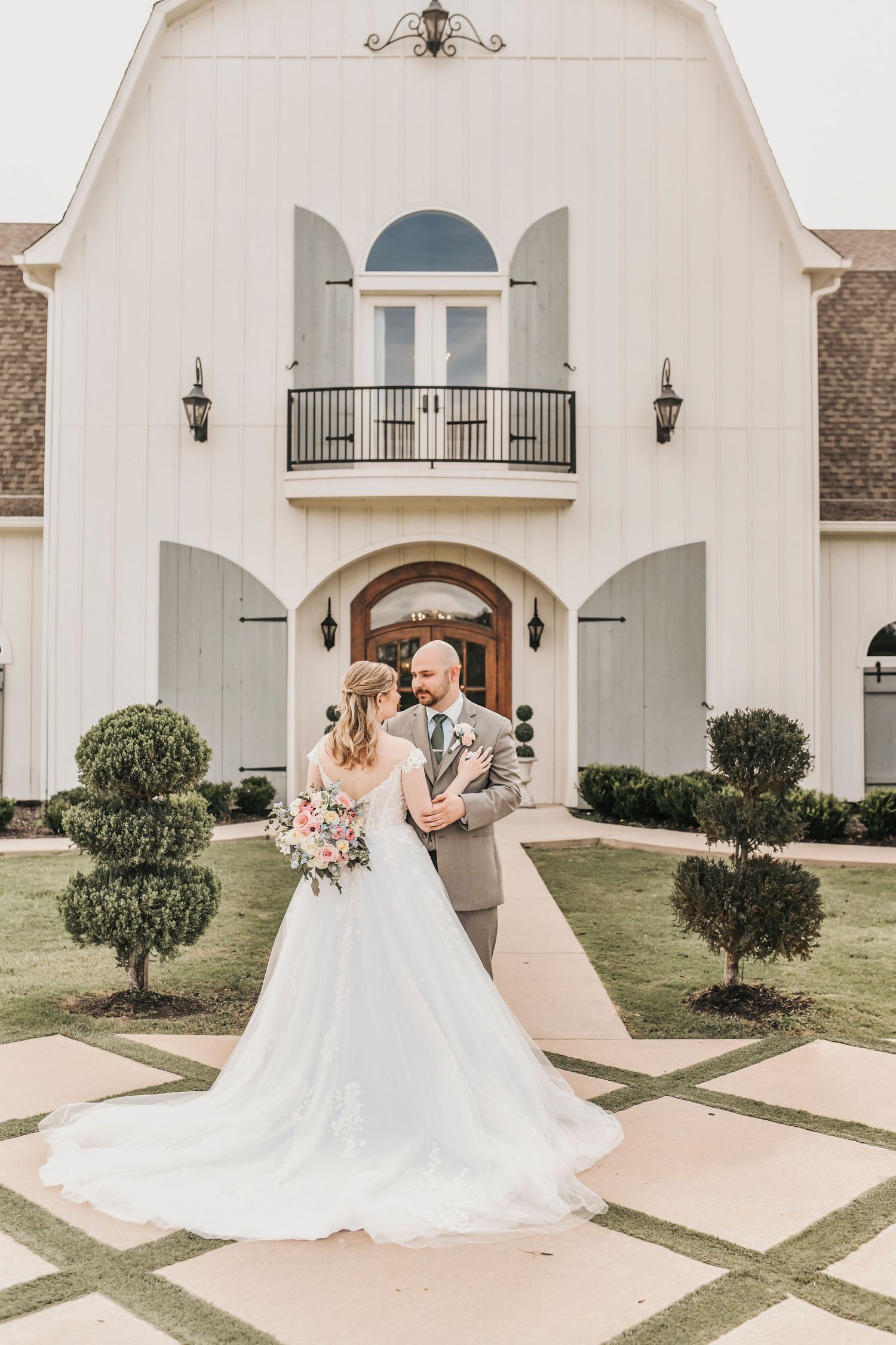 Bride and groom portrait in front of the iconic French Farmhouse exterior