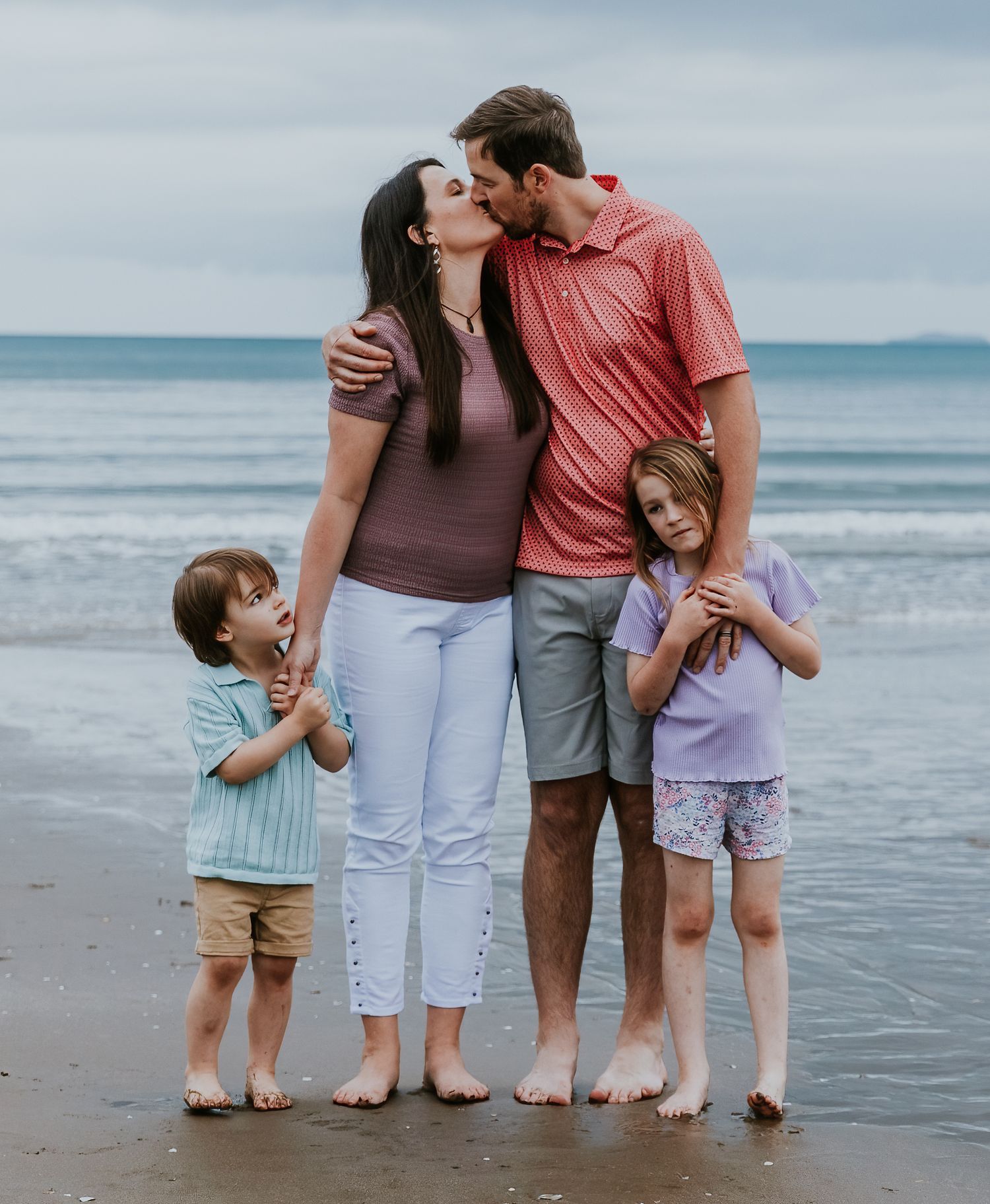 Auckland family photography of parents with their two children at the beach