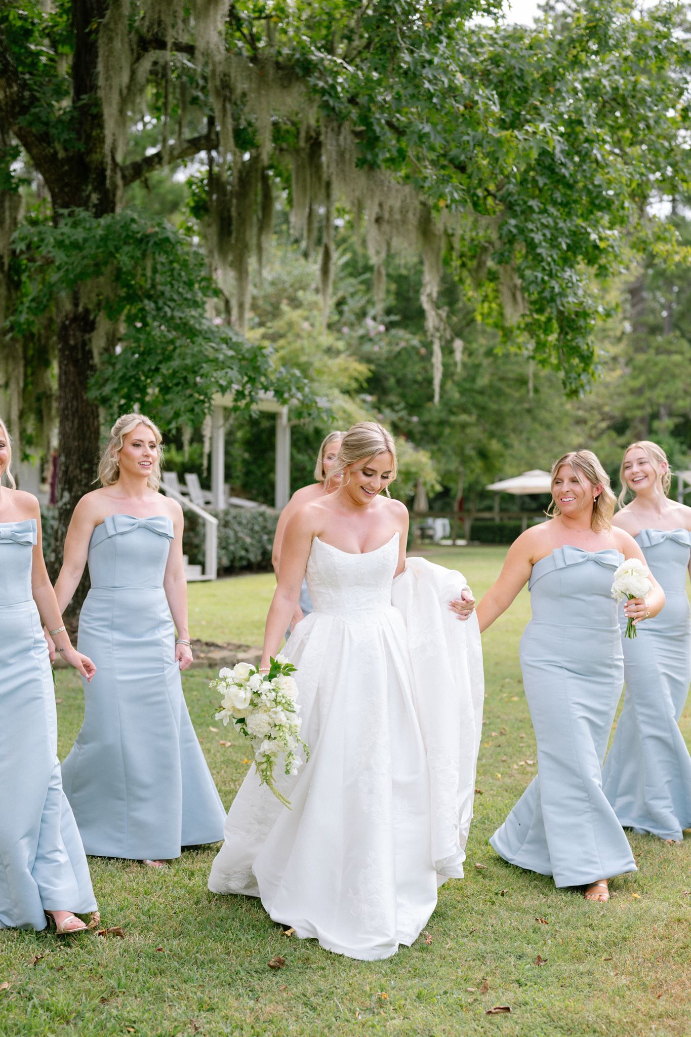 Bride wedding party walking at Historic Hill House in Willis Texas.