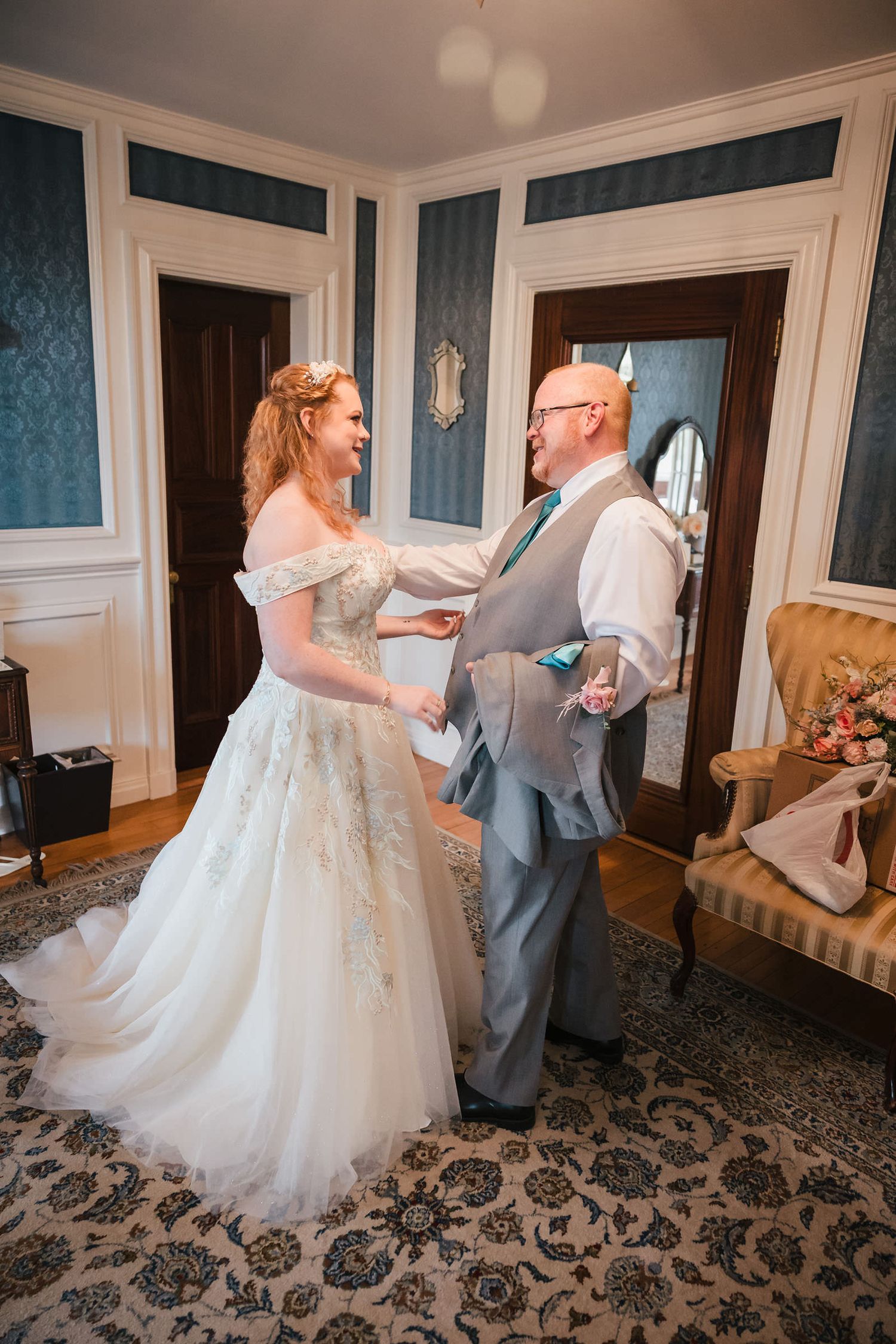 Bride and her father sharing an emotional first look, both laughing and tearing up, at Searles Castle.