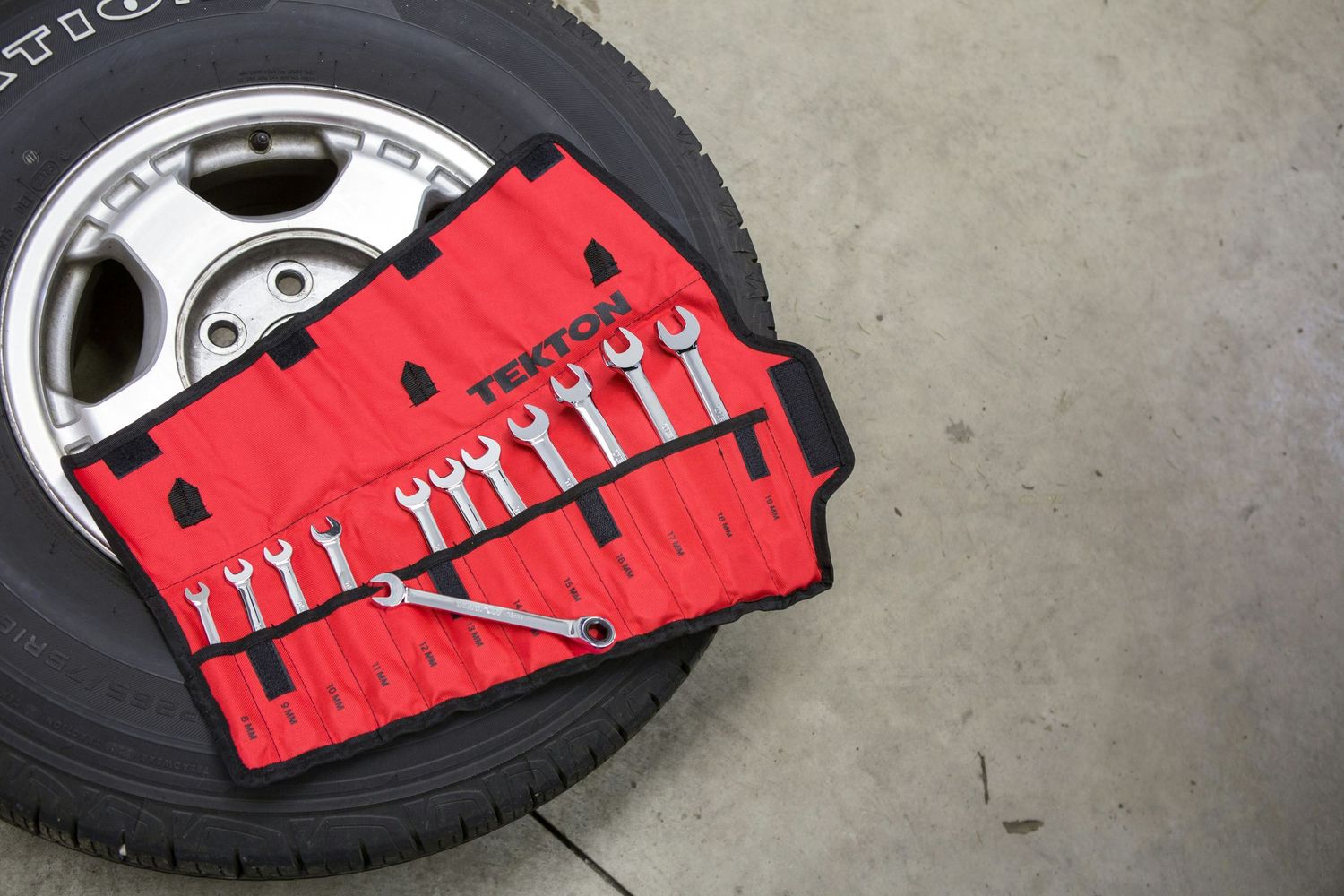 Automotive repair tools beside a vehicle tire used for mobile mechanic service in Independence, MO.