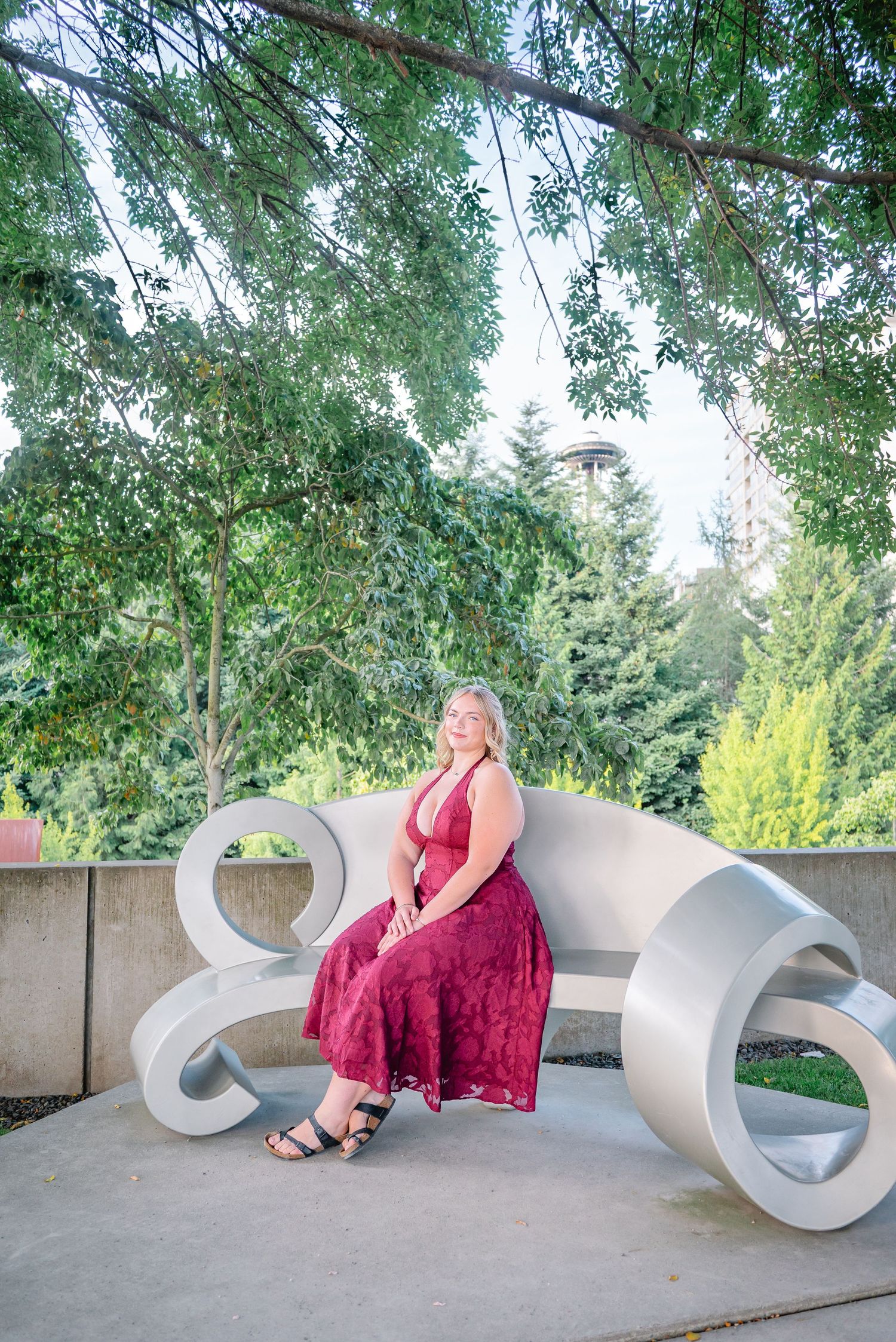 Senior seated beside a curved outdoor sculpture at Olympic Sculpture Park in Seattle