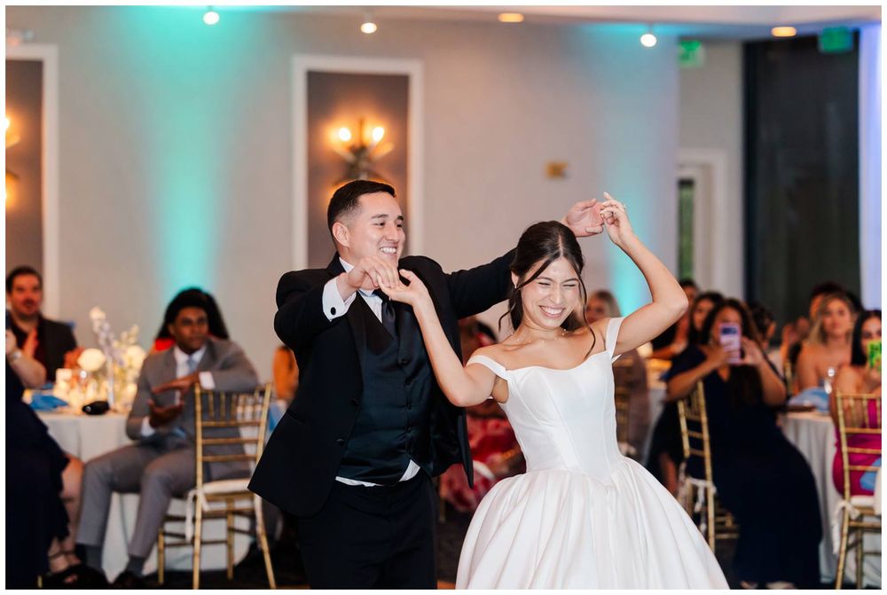 Bride and groom sharing a joyful first dance at their elegant wedding reception.