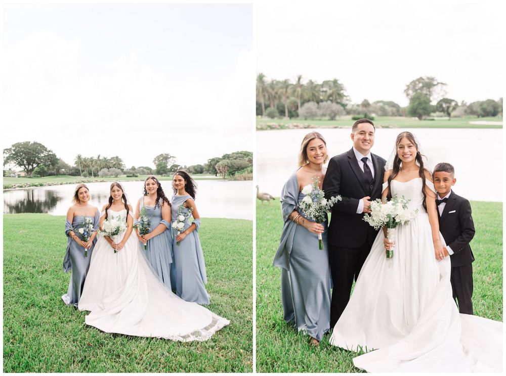 Bride with bridesmaids in dusty blue dresses and groom with family posing near pond.