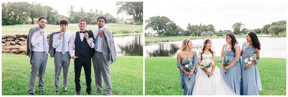 Wedding party poses outdoors near a lake, groomsmen in gray suits and bridesmaids in blue dresses with bride holding white bouquet.