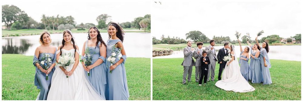 Bride with bridesmaids in dusty blue gowns and groomsmen in gray suits posing on green lawn near pond.