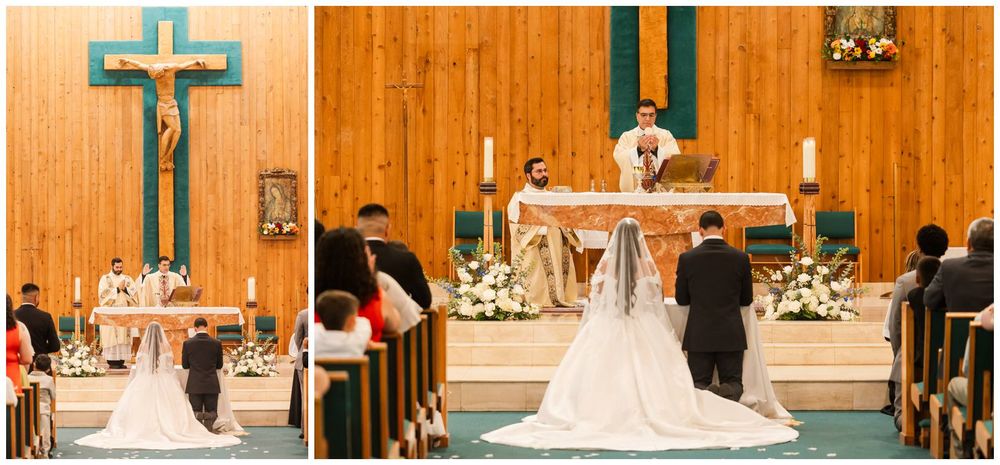 Bride and groom exchange vows at a wooden Catholic church altar decorated with white floral arrangements.
