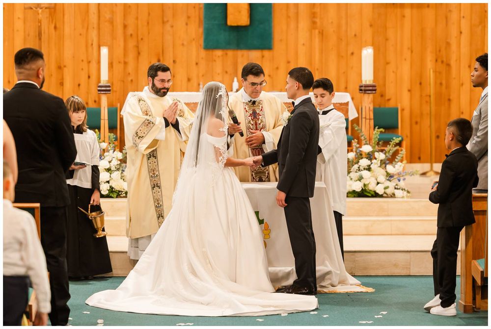 Bride and groom exchanging vows at church altar during traditional wedding ceremony.