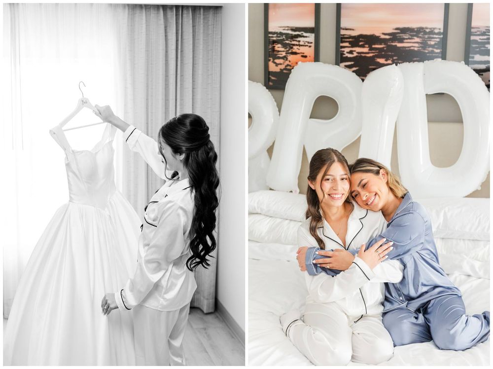 Bride in satin robe admires wedding gown and takes selfie with bridesmaid beside BRIDE balloons.