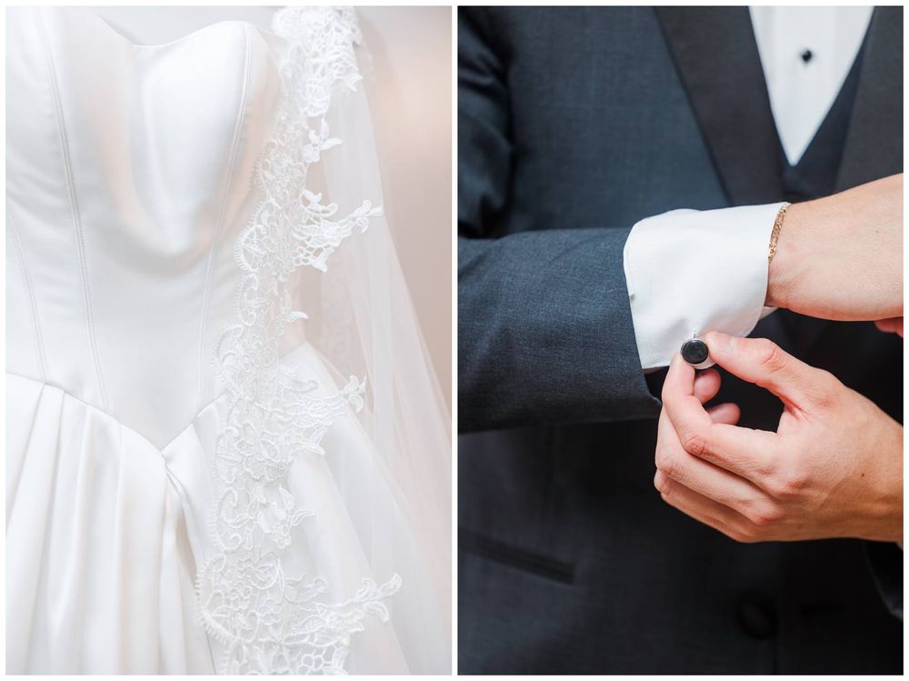 Elegant wedding dress with lace details hanging beside a groom fastening his cufflinks in a dark tuxedo.