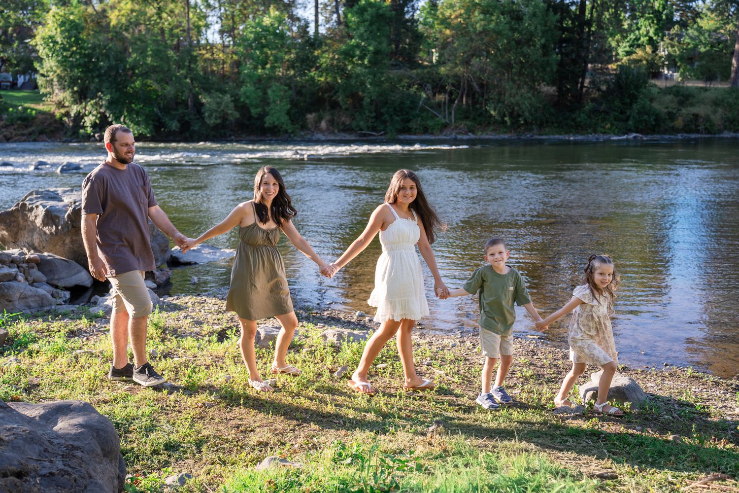 family of 5 walks by the river