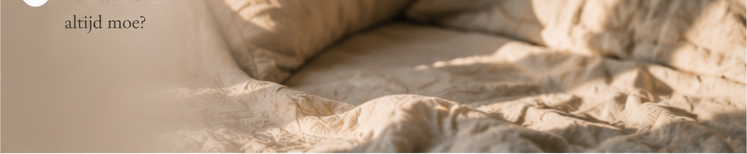Crumpled beige linen bedding with soft natural texture, creating a cozy and relaxed bedroom aesthetic.