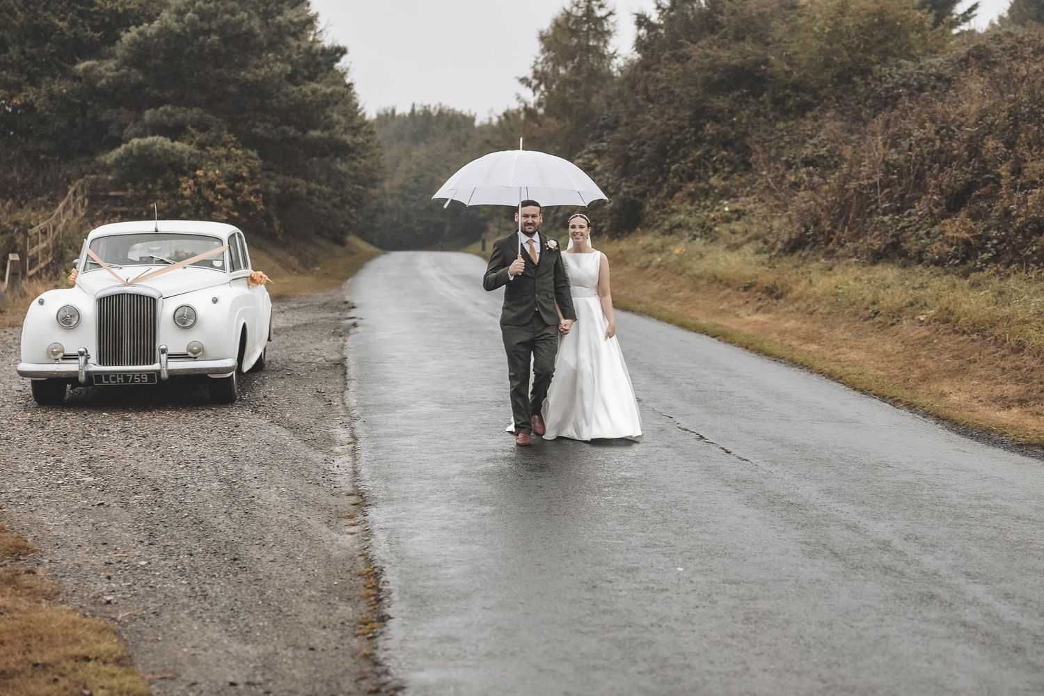 Couple embracing the UKs diverse weather on their wedding day