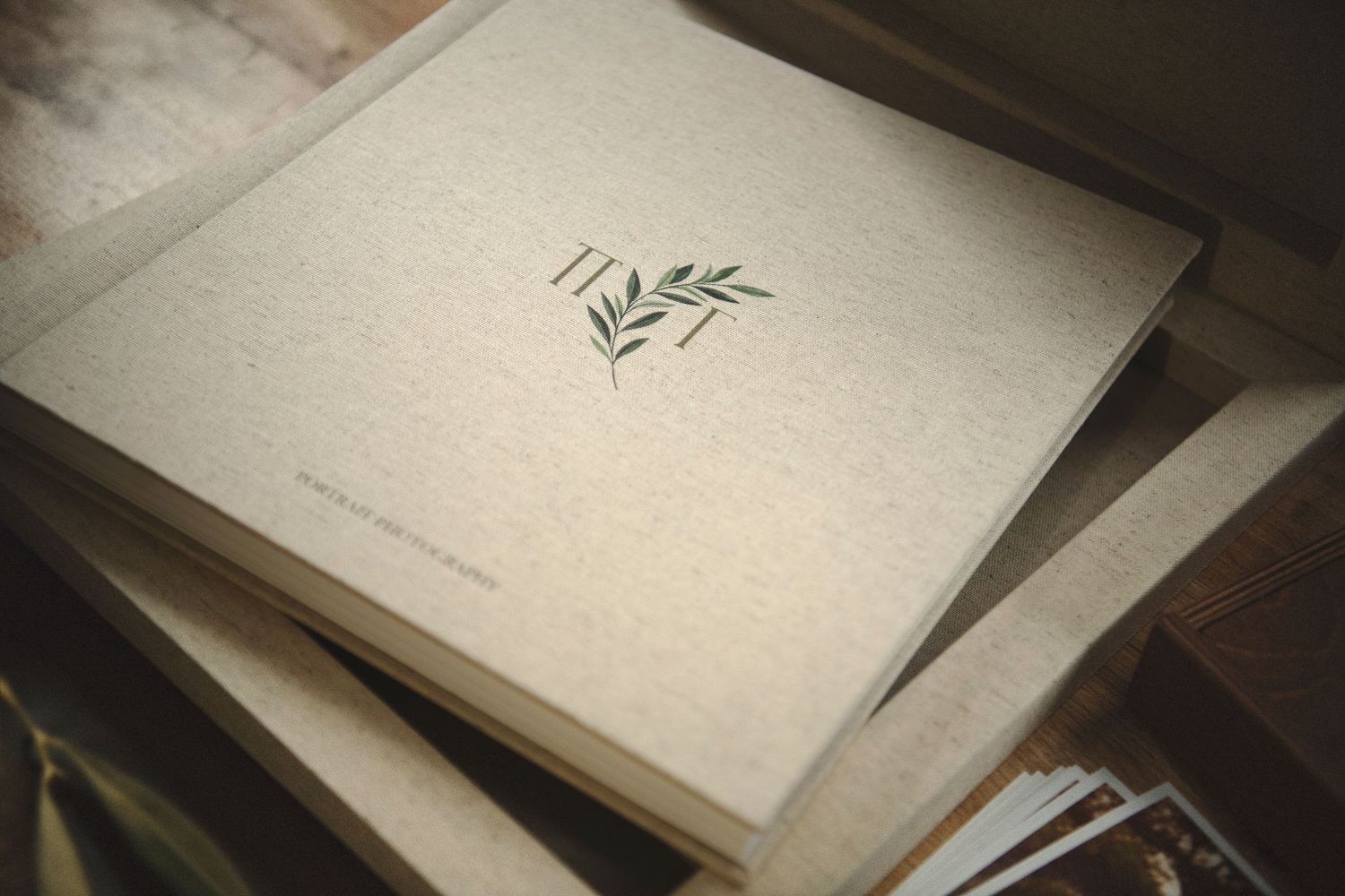 Minimalist fine art wedding album with an organic linen cover and custom botanical monogram embossing.