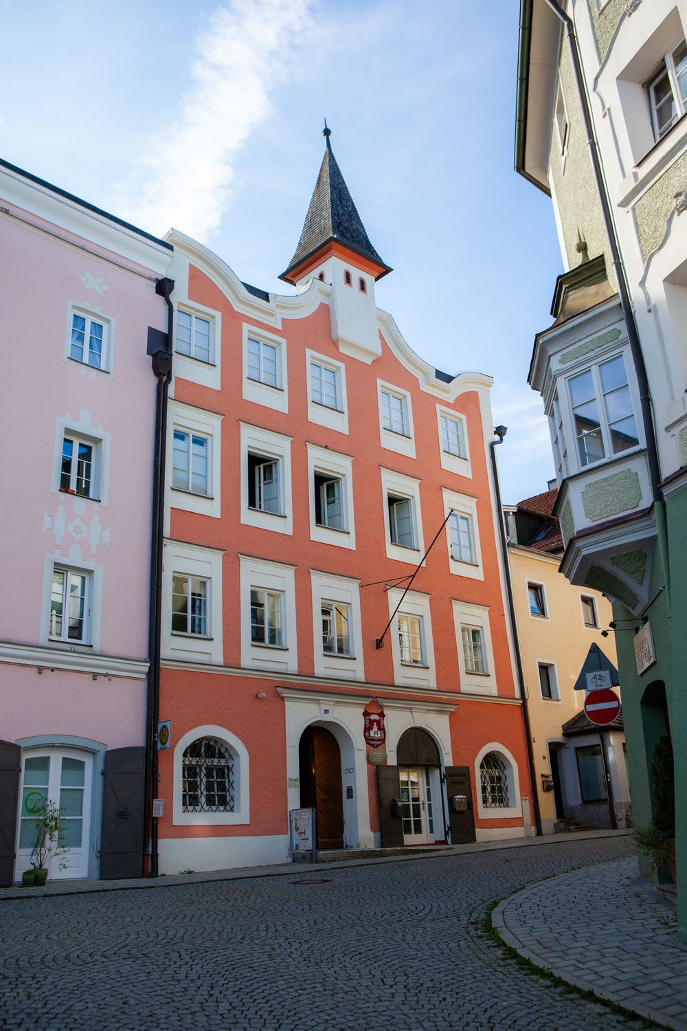 Colorful historic buildings with cobblestone street in a charming European old town square.