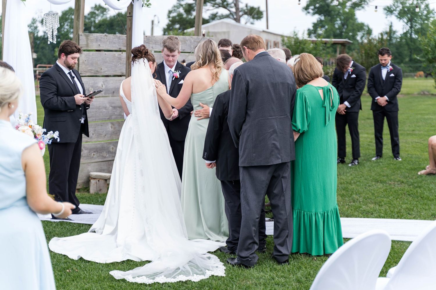 families pray over couple