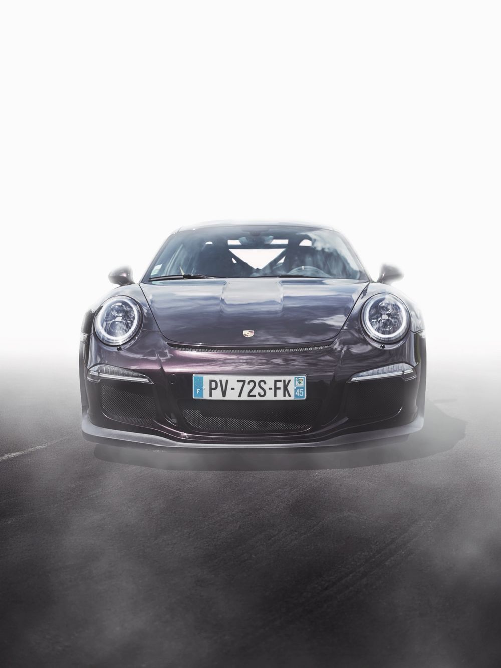 Dark purple Porsche 911 GT3 sports car front view on track with French license plate PV-72S-FK.