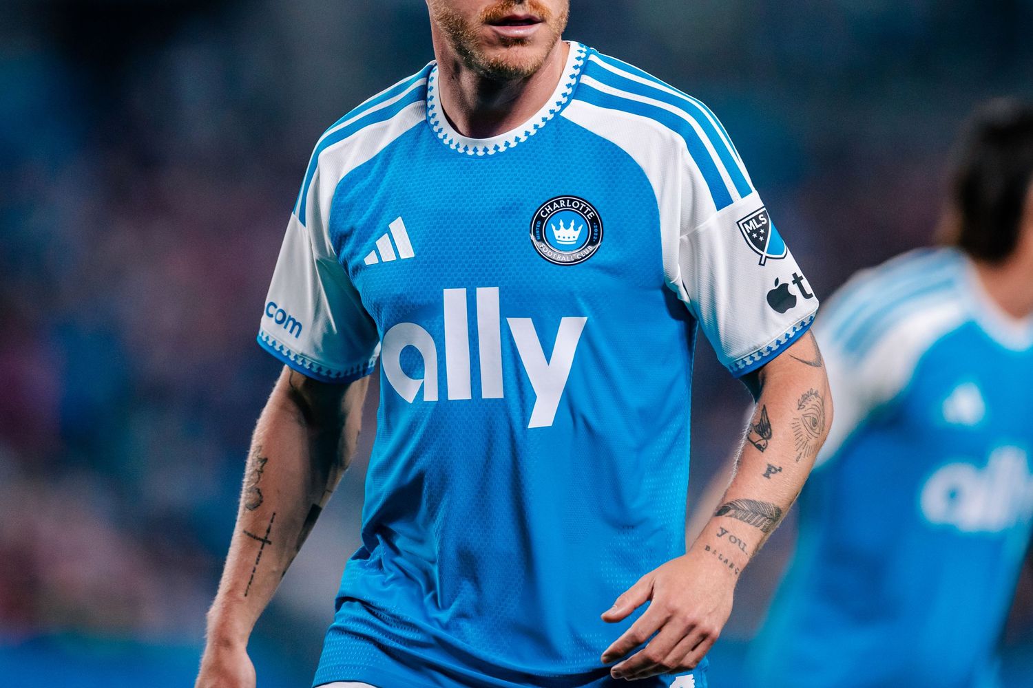 Charlotte FC soccer player wearing blue Adidas ally jersey during an MLS match.