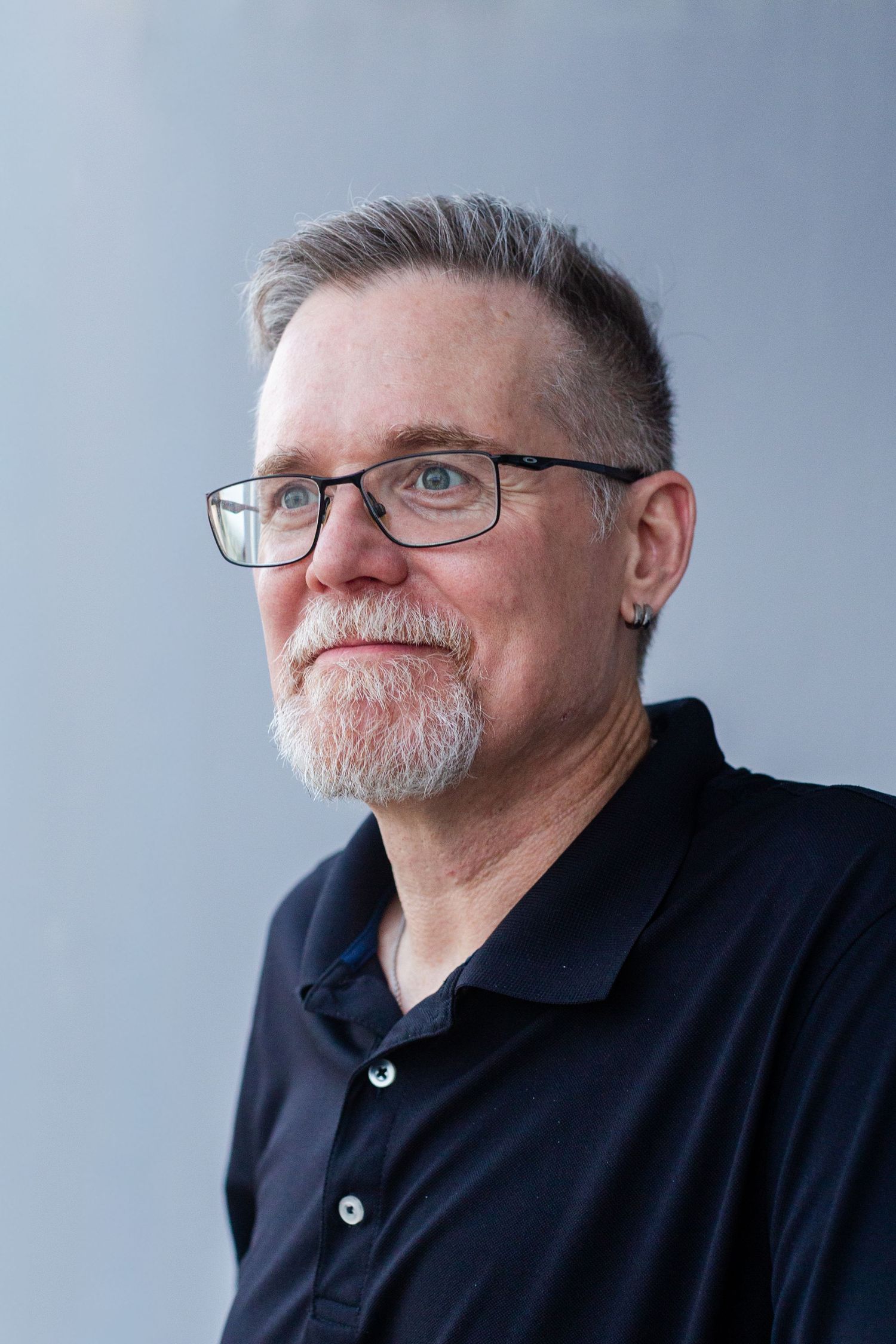 Headshot of a man against a gray background. Guaynabo, Puerto Rico.