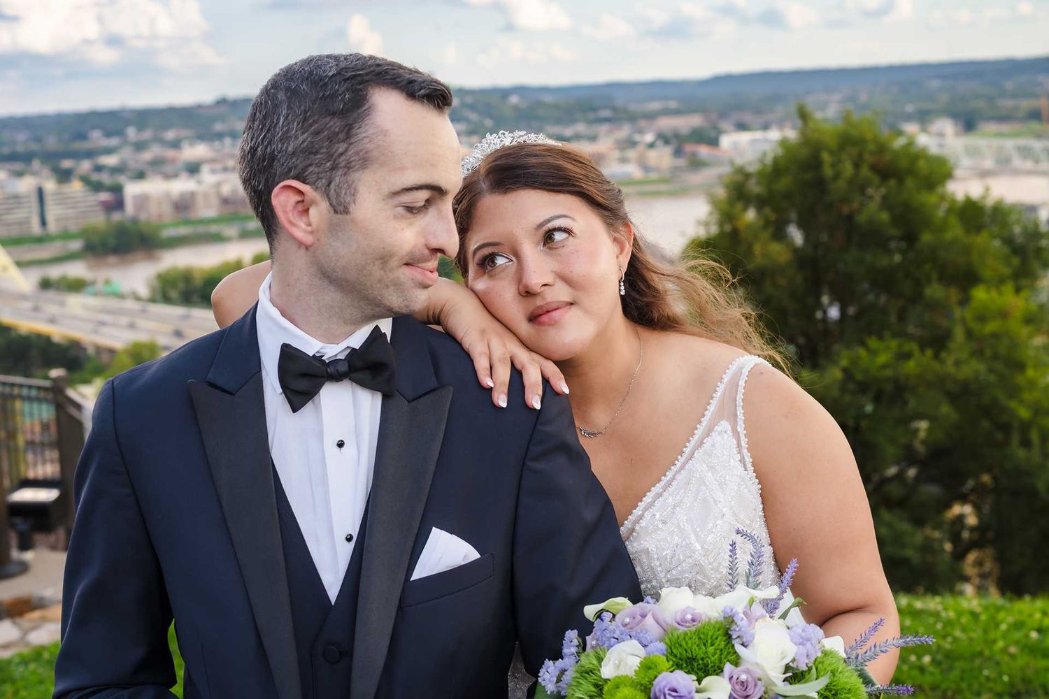 Bride and groom share a romantic moment outdoors, at the view wedding venue