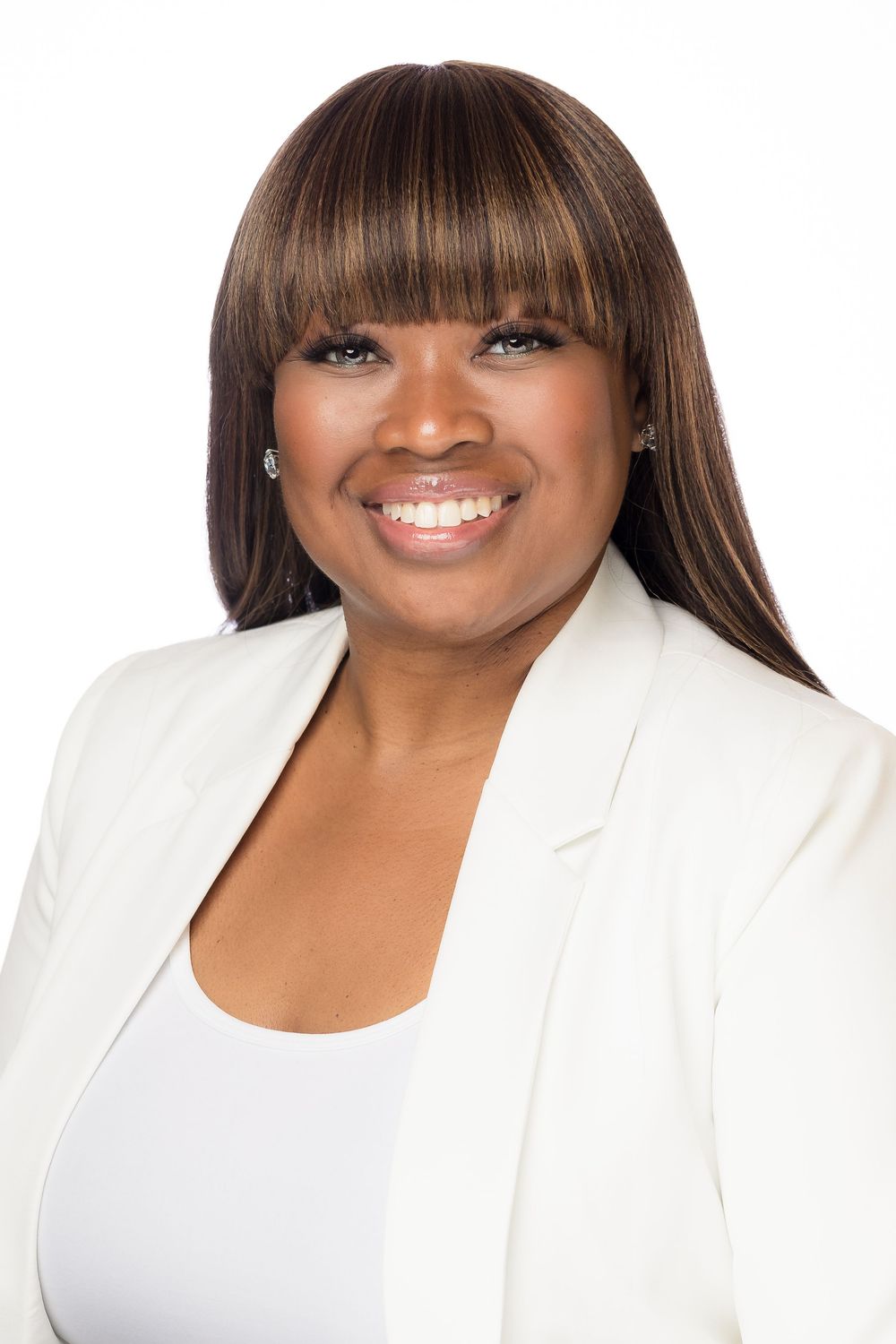 Professional headshots of a person in a white blazer showing different smiling expressions.