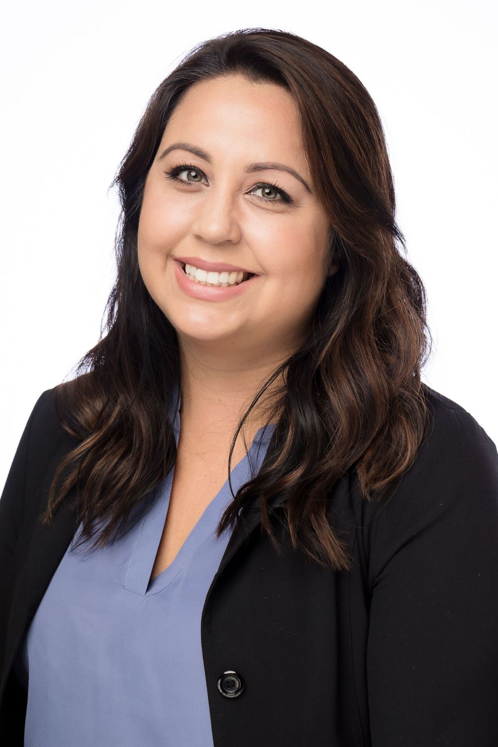 Professional headshots showing person in black blazer and purple top with warm smile against white background.