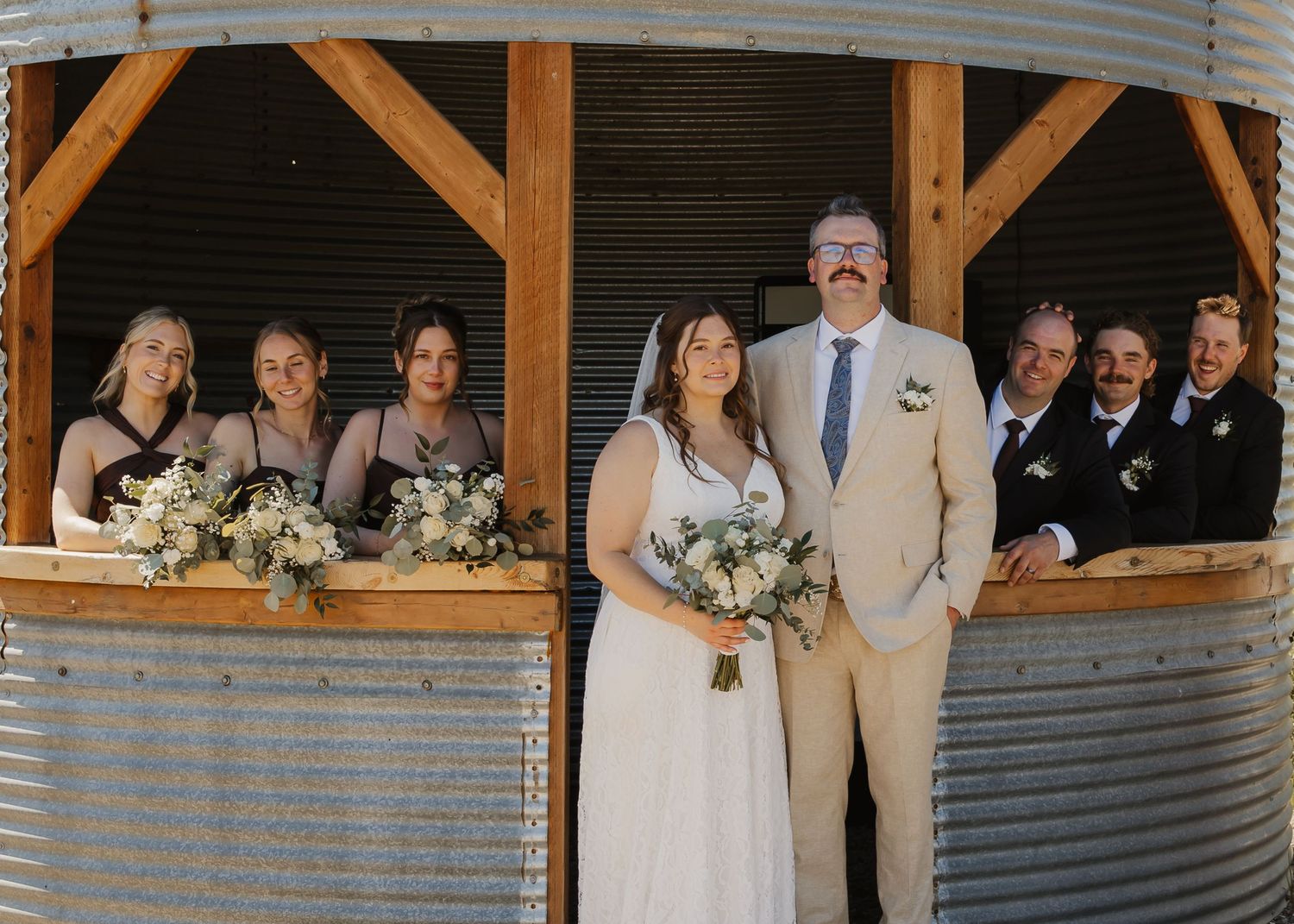 Bride and groom with wedding party during an outdoor Alberta wedding celebration”