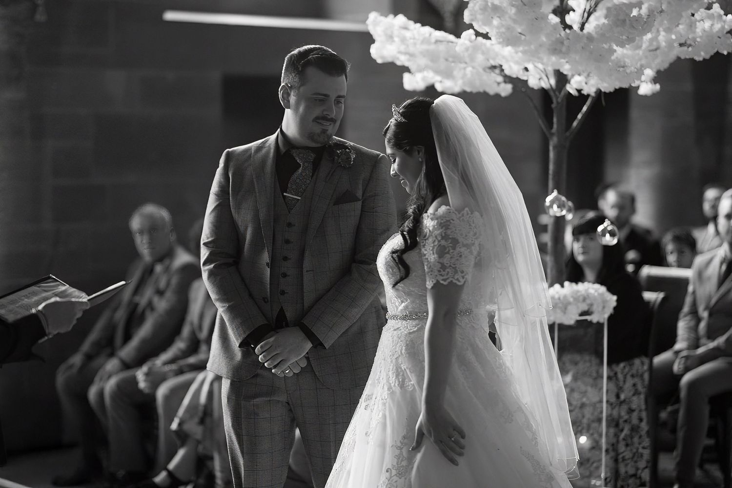 Bride and groom look into each others eyes whilst standing on the balcony at Shrigley Hall in Cheshire