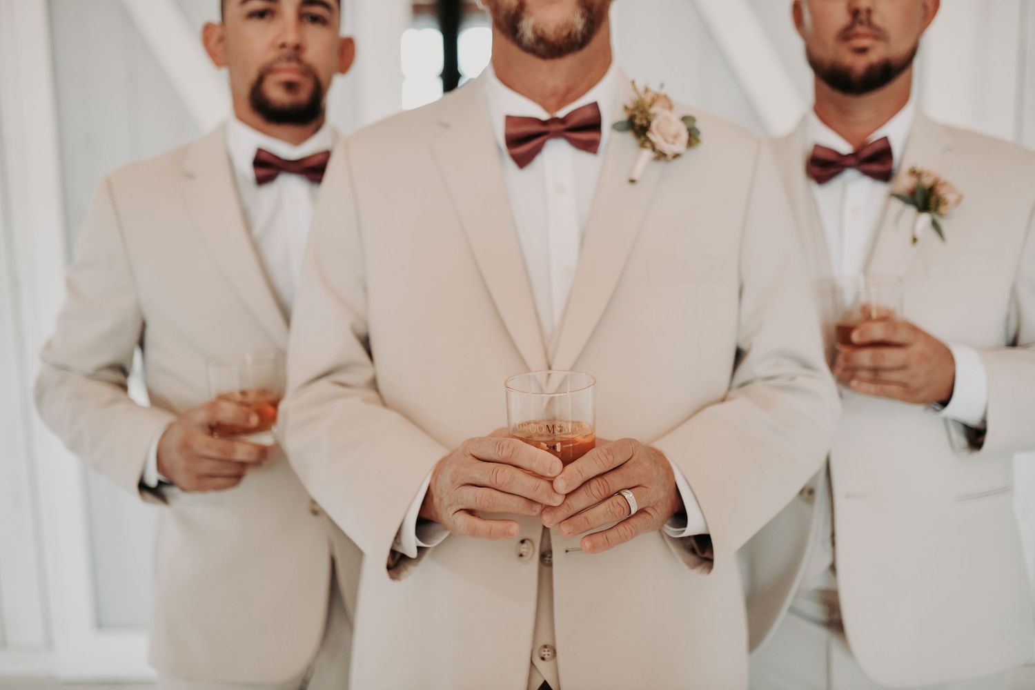 Neutral linen groom suit paired with a soft mauve wedding bow tie