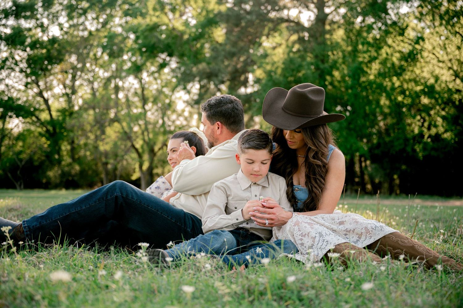 Family enjoying a relaxed outdoor photo session surrounded by rustic barns and open fields at Good Vibes Farm.