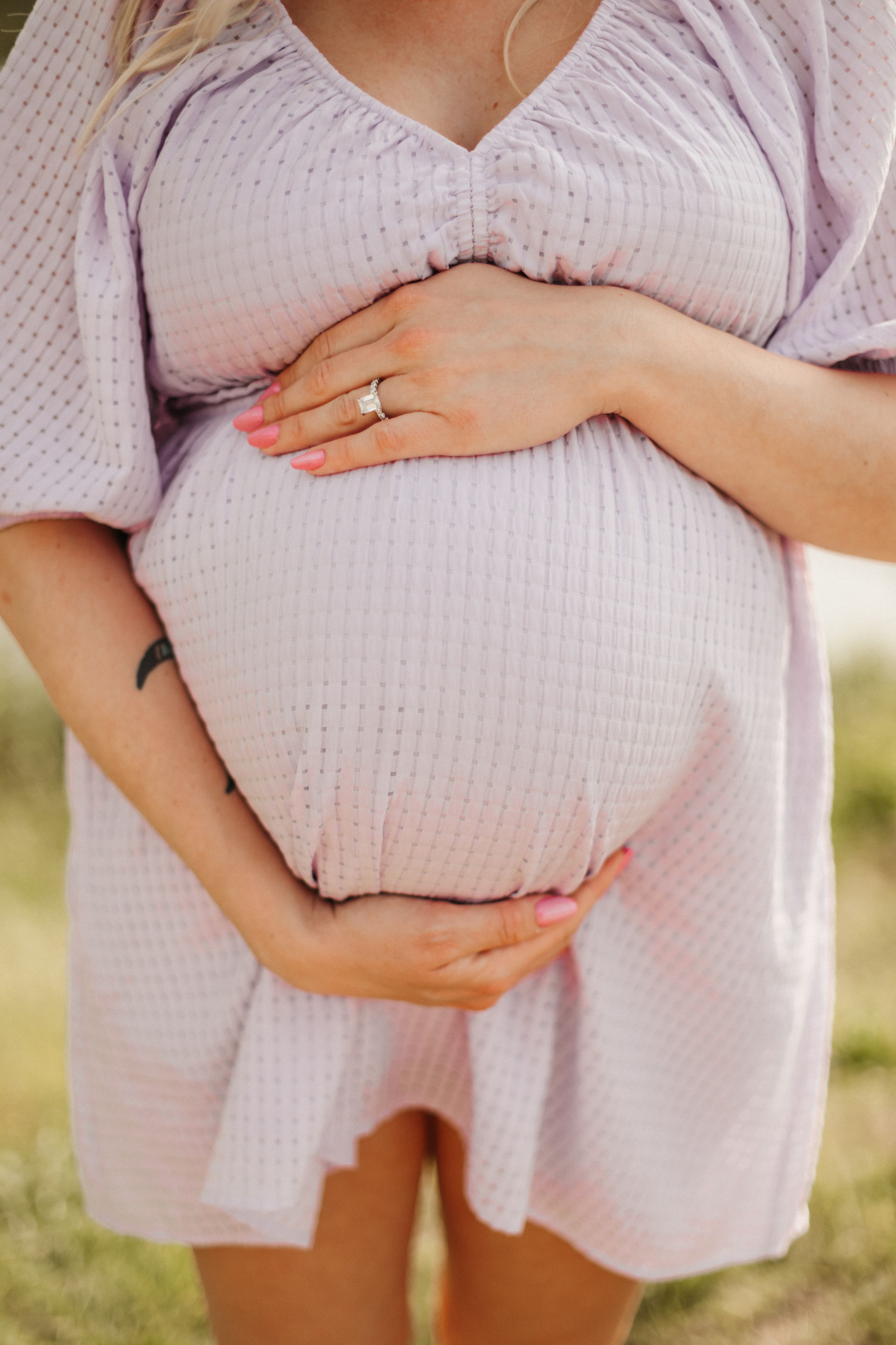 Close-up collage showing a pregnant belly in a pink dress with hands cradling the bump at different angles in outdoor setting.