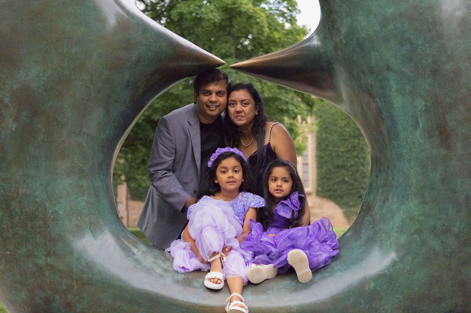 Family in purple framed inside an outdoor sculpture at Princeton University, creative NJ family photos