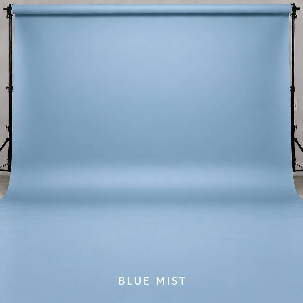 Blue Mist seamless paper backdrop displayed on a professional photography backdrop stand in a studio setting.