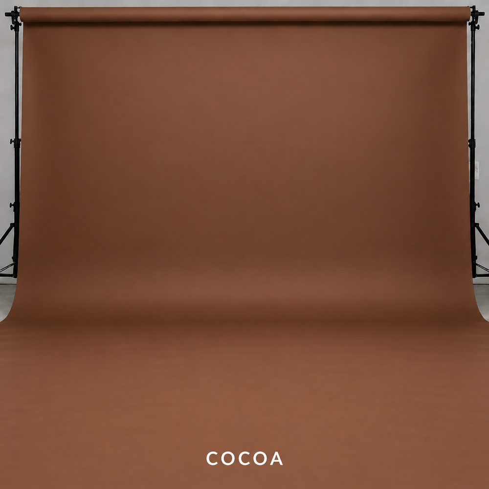 Cocoa brown seamless paper photography backdrop on studio stands, perfect for portraits and product photography.