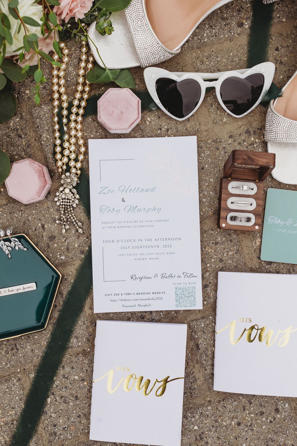 Engagement ring and wedding bands displayed on wedding stationery.