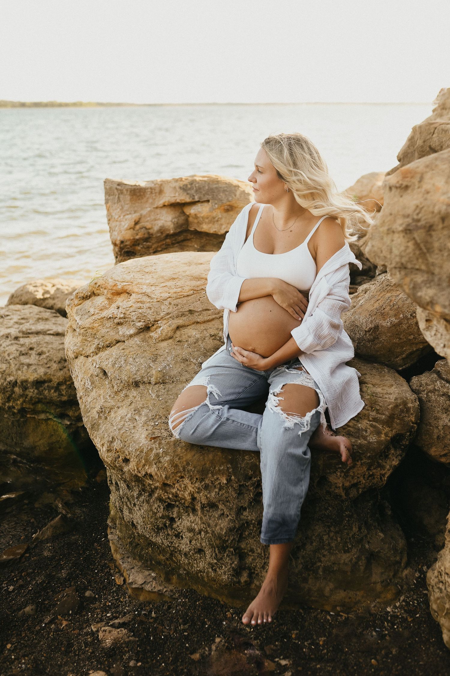 Expecting couple embracing during a relaxed Lake Grapevine maternity photography session