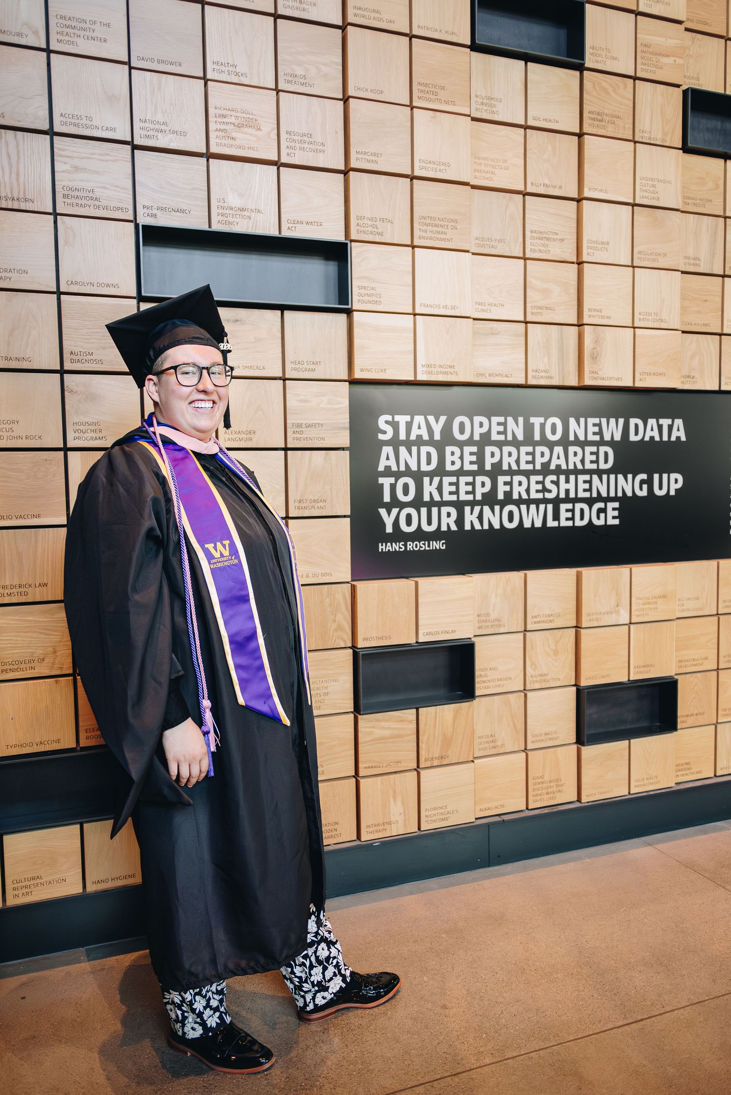University of Washington master's graduate in a cap, gown, and hood.