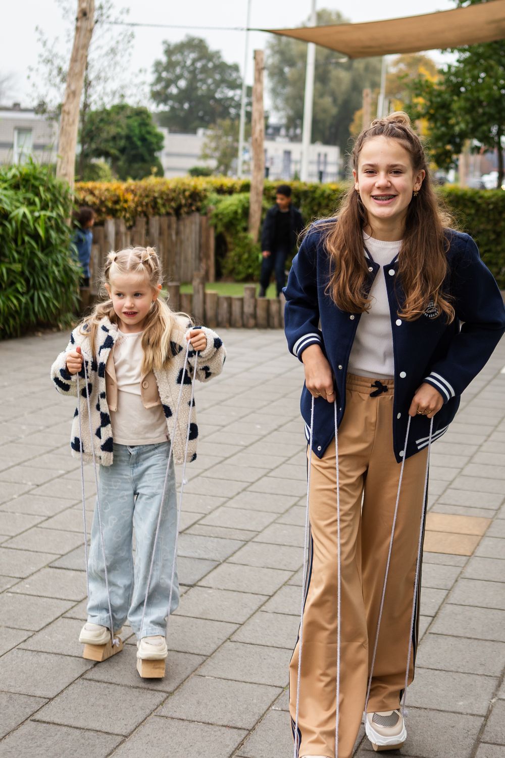 Five sequential photos showing a child using forearm crutches to walk on a paved outdoor path.