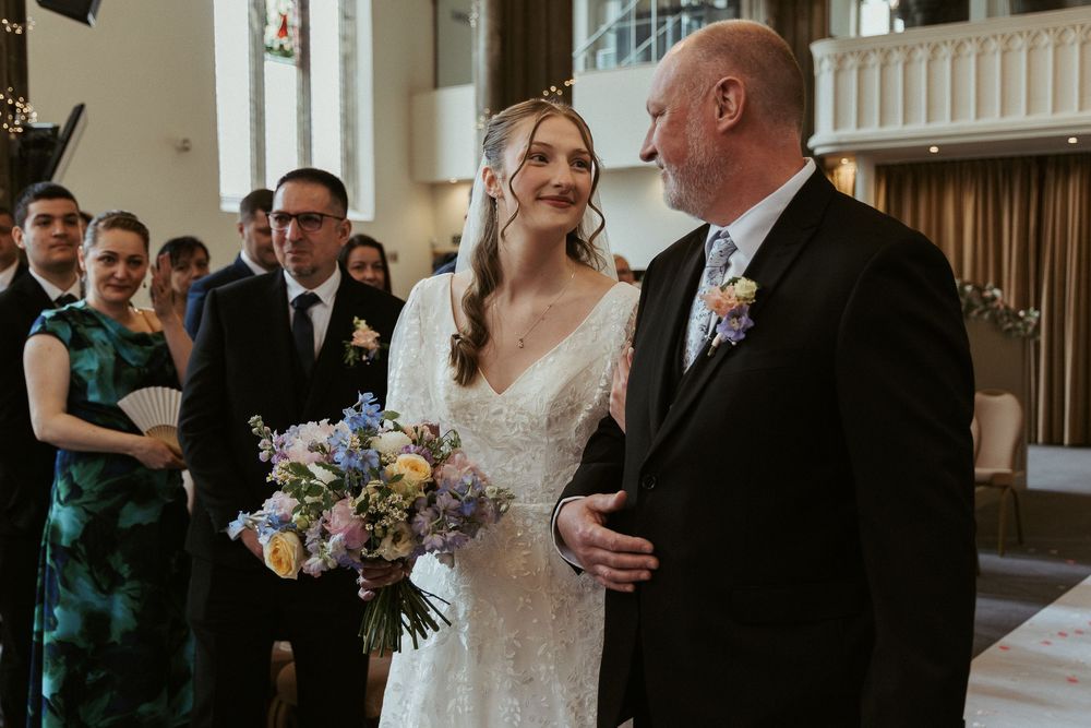 Walking down the aisle with father of the bride moment at a church wedding by Chelle Lundy Photography