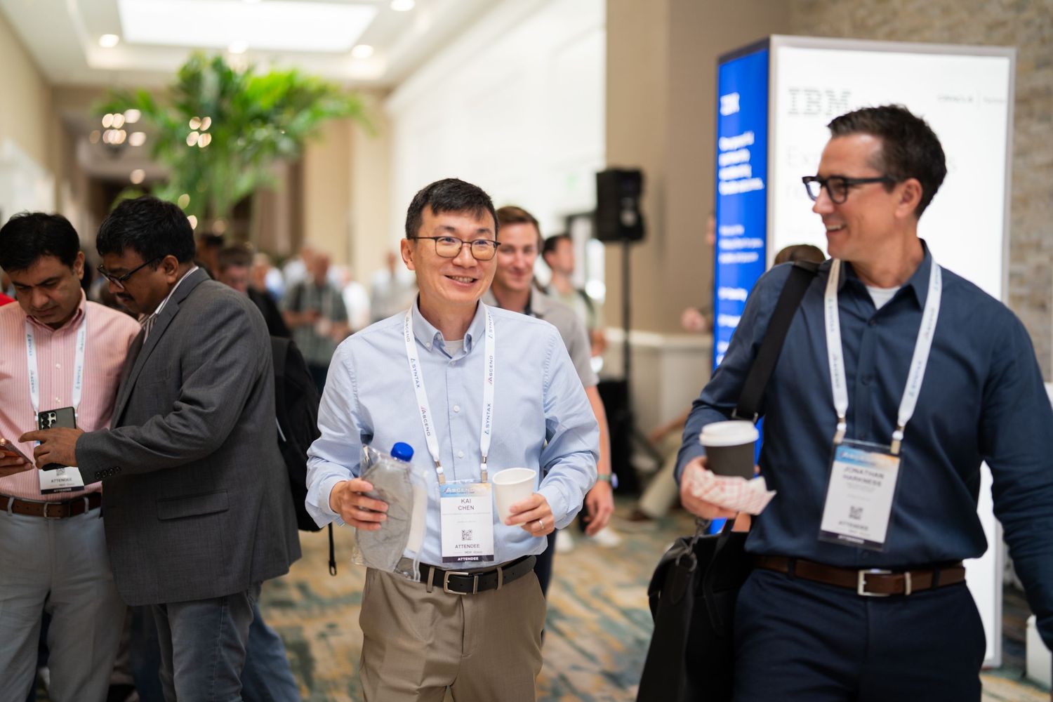 Orlando convention photographer Ray Alvarez — attendees networking in conference hallway at corporate convention with IBM signage