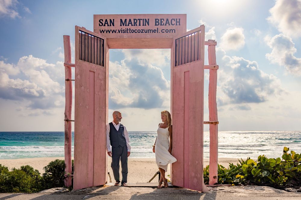 Couple photOshoot at San Martin Beach Cozumel with turquoise Caribbean Sea in background.