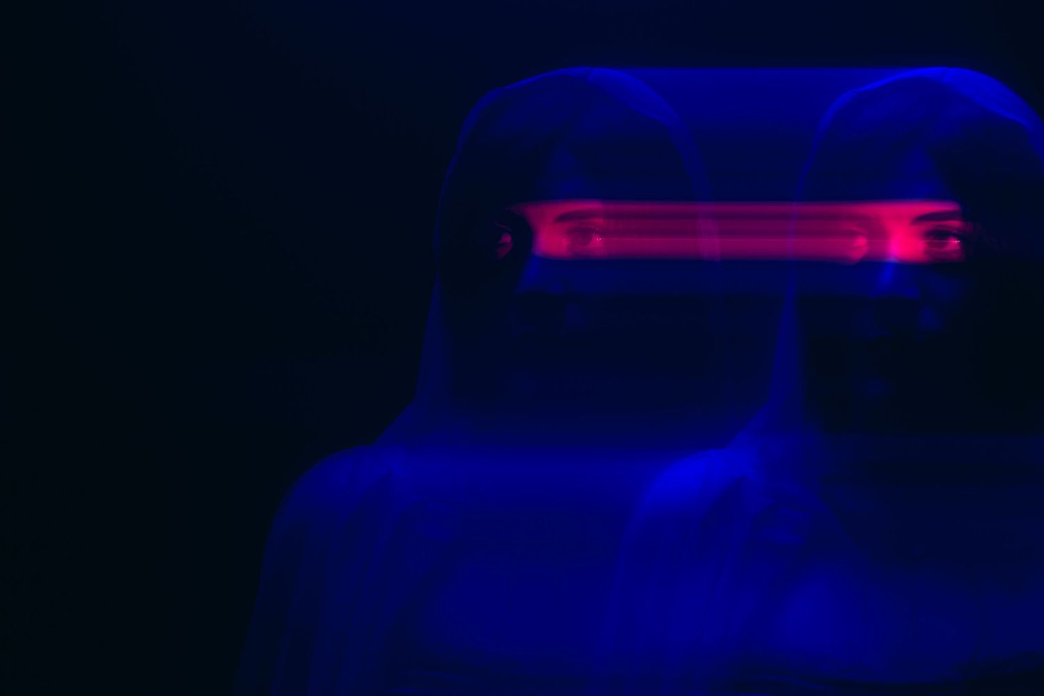 Abstract portrait with a red light bar glowing across a blue silhouette, Miami studio | Mannyportraits