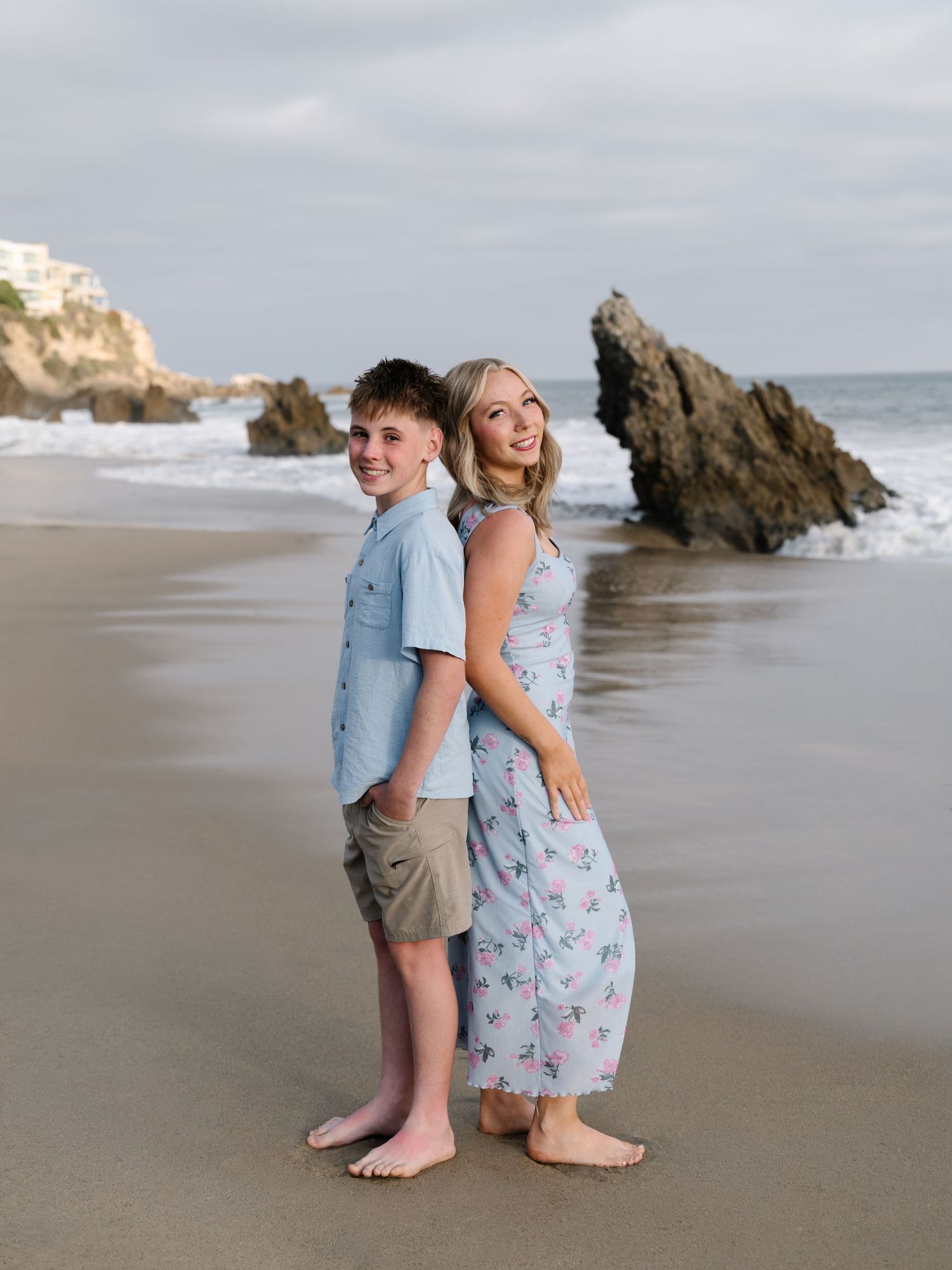 Brother and sister posing together during a Newport Beach extended family beach photography session.