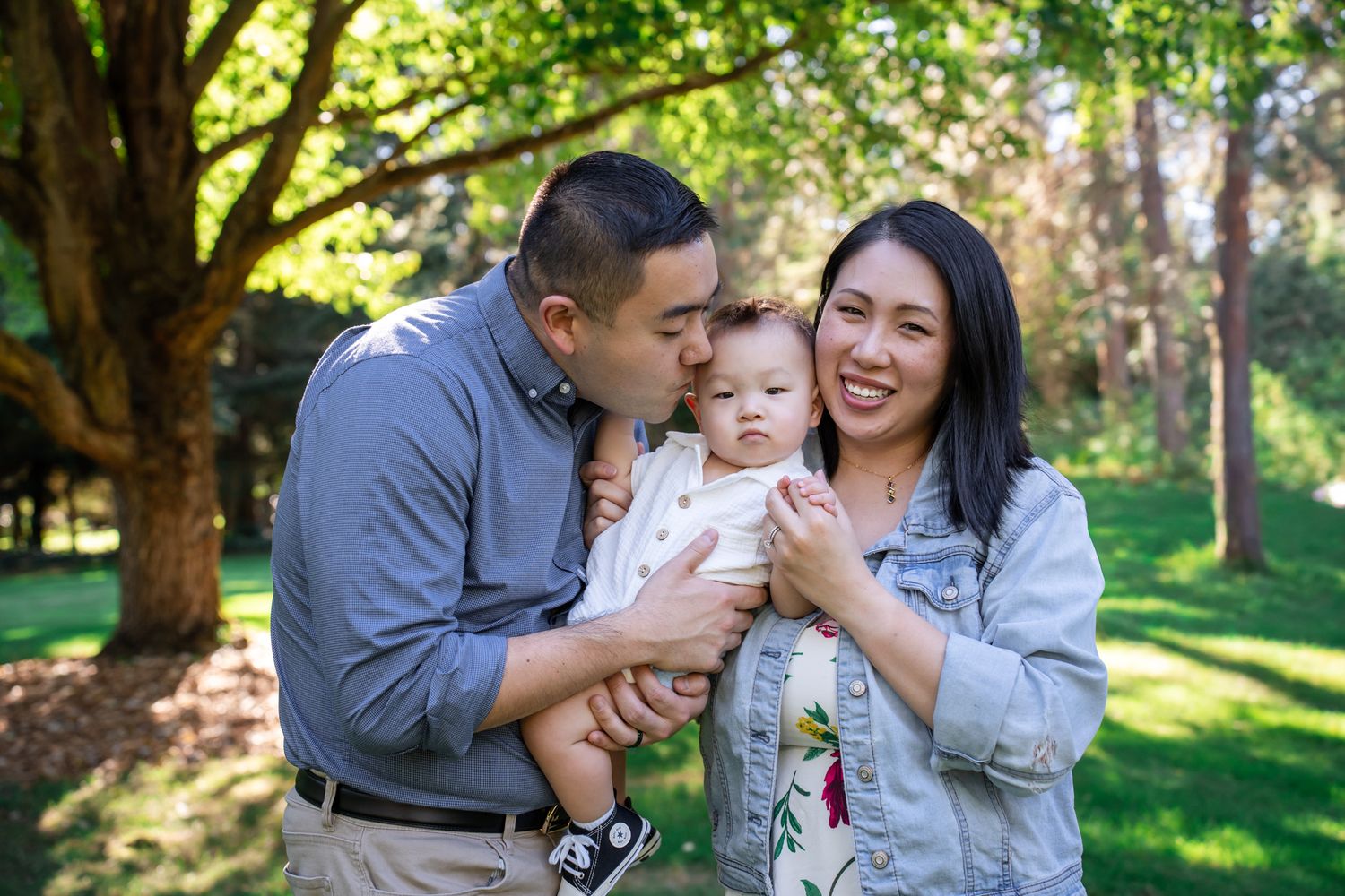 Family portrait with parents loving on baby boy
