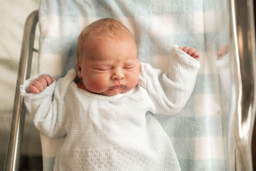 Newborn baby sleeping peacefully in hospital bassinet at Parkwest Medical Center in Knoxville, TN.
