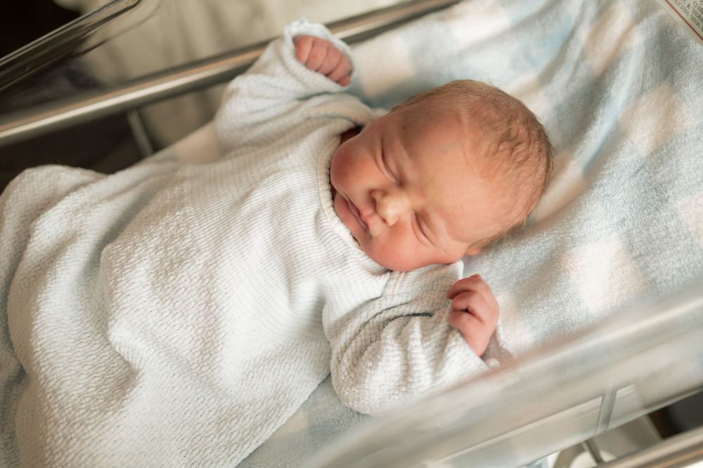 Newborn baby sleeping peacefully inside hospital bassinet at Parkwest Medical Center in Knoxville, TN.