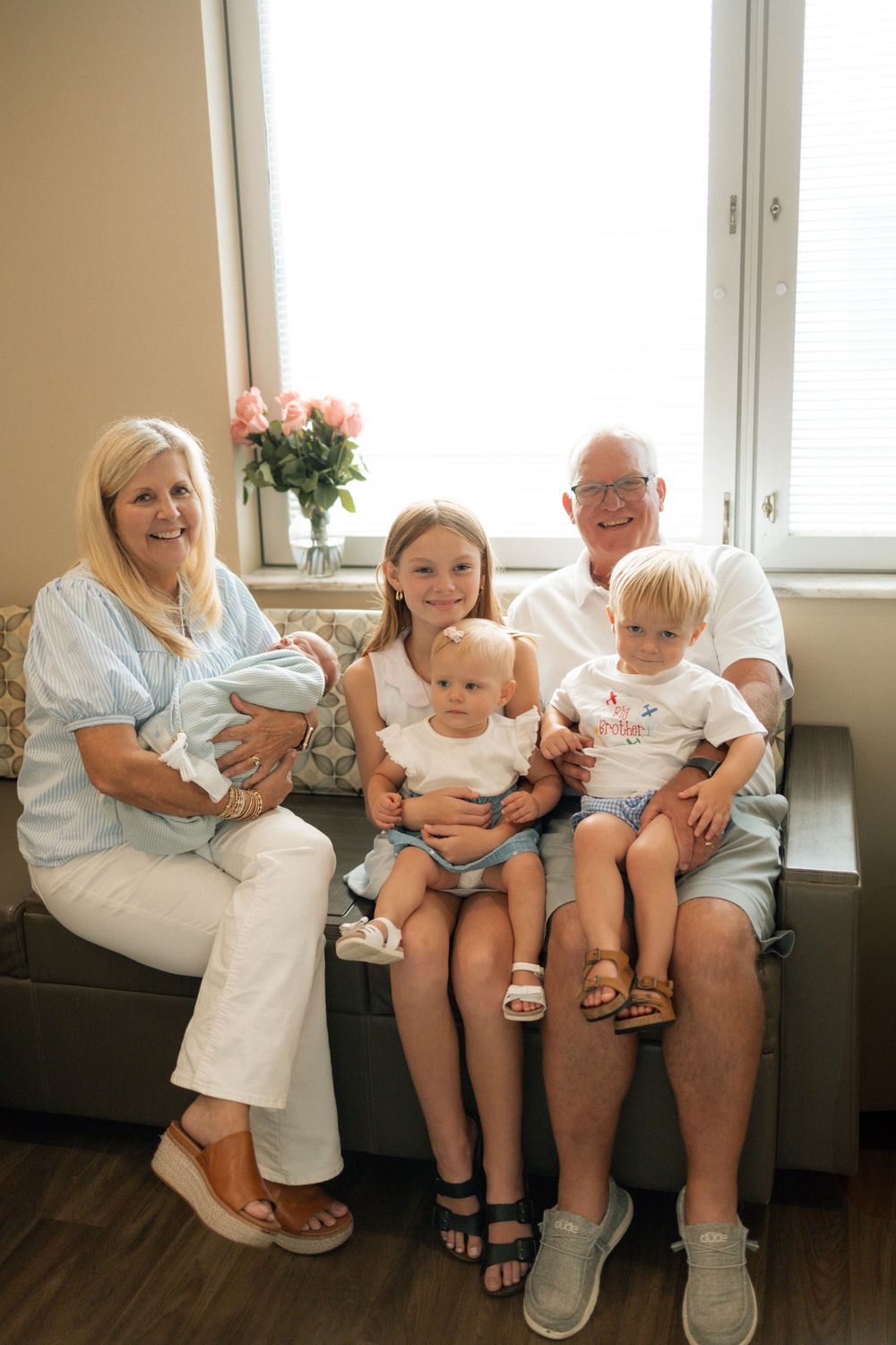 Grandparents sitting on a couch with four young grandchildren, including a newborn baby at Parkwest Medical Center in Knoxville, TN.