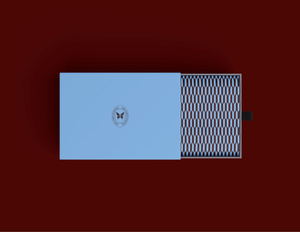 Elegant light blue gift box with butterfly emblem and geometric patterned interior on deep red background.