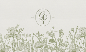 Delicate botanical wedding monogram design with hand-drawn wildflowers and intertwined letters on cream background.