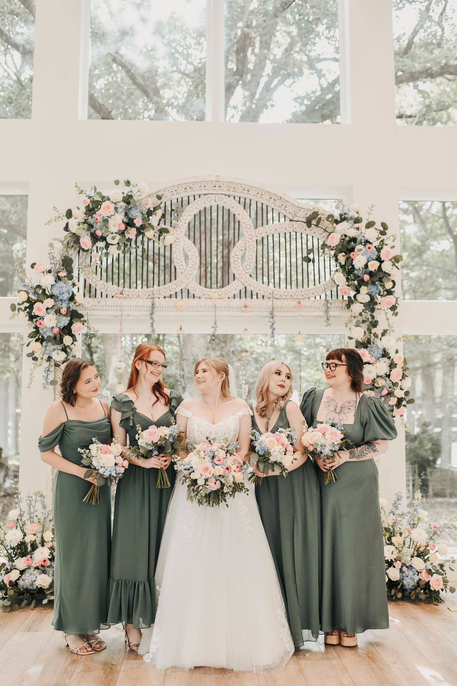 Full wedding party portrait in front of The French Farmhouse reception hall